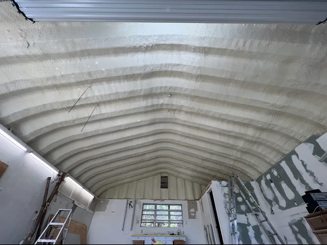 Spray polyurethane foam applied to the underside of a metal roof deck in Peabody